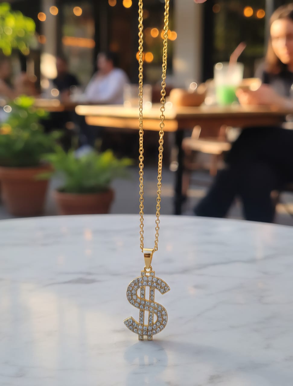 Gold tone diamond dollar sign pendant