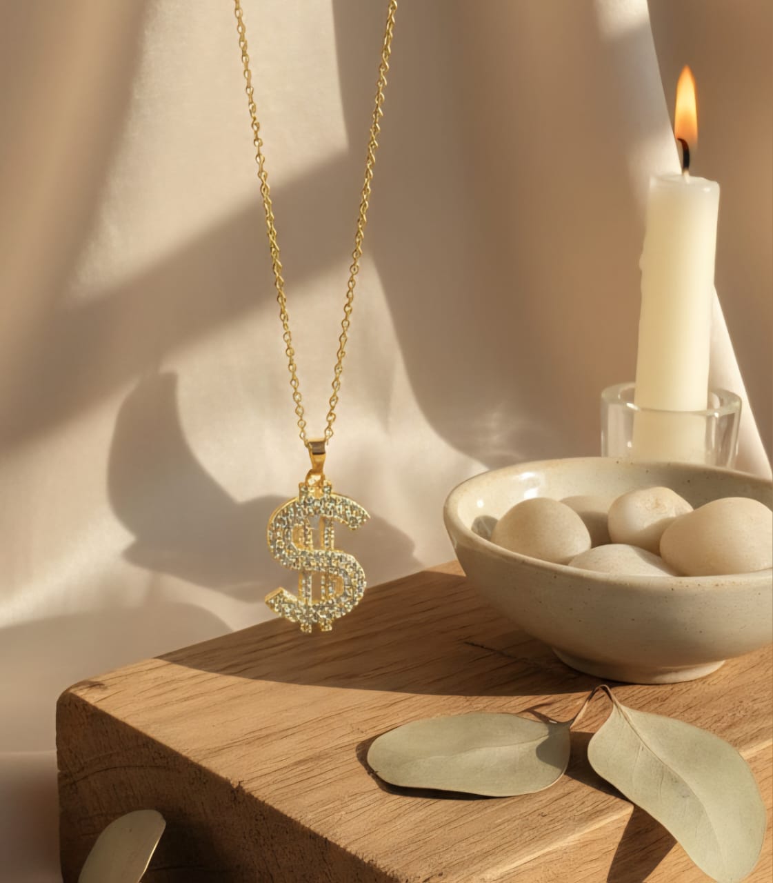 Gold tone diamond dollar sign pendant