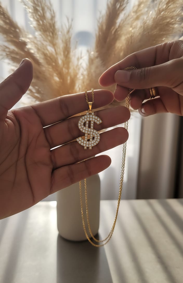 Gold tone diamond dollar sign pendant